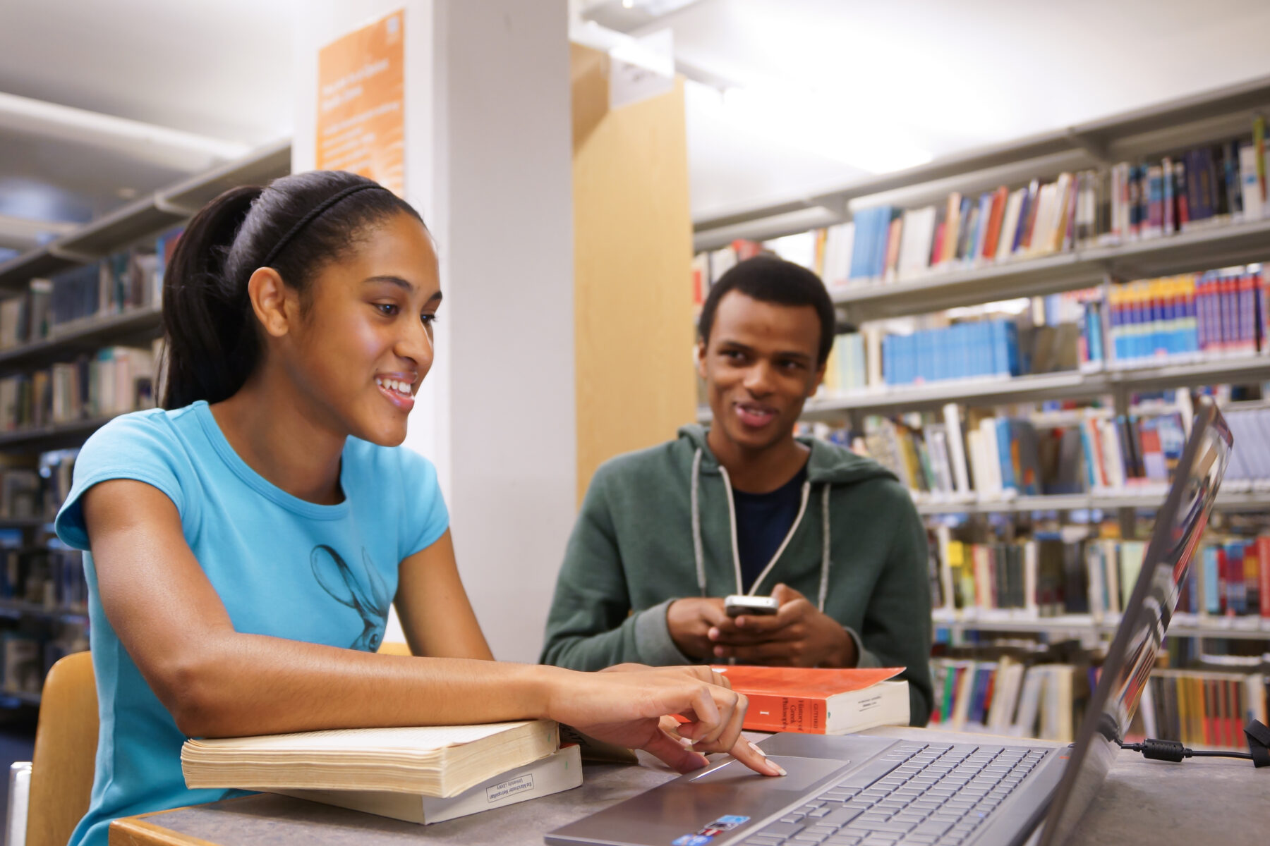 Two students sitting at a table in a library